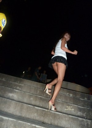 Девушка из Сингапура показывает пизду под юбкой катаясь на эскалаторе
